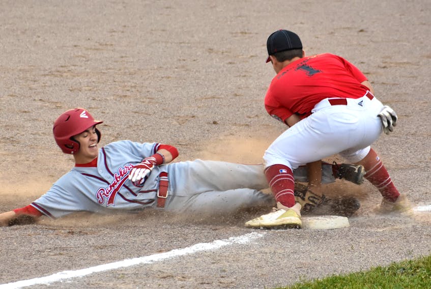 Tye Clarke of the Cape Breton Ramblers, left, slides into third base as Stefano Paolucci of Diamond Baseball Academy of Mirabel, Que., slaps the tag on him during Canadian Senior Little League Championship action at the Nicole Meaney Memorial Ball Park in Sydney Mines on Monday. Clarke was called out on the play. The Quebec representative won the game 12-2 after five innings of play.