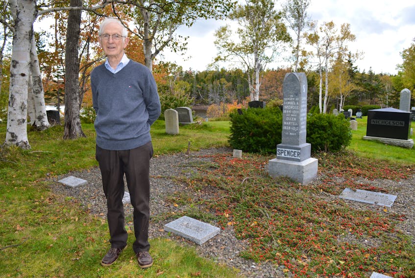 Allister Spencer, treasurer and a trustee at St. John’s United Church in Port Morien, stands by the gravesite of many of his relatives at the Black Brook Cemetery.  A meeting is being held at the church on Sunday at 2 p.m., to discuss options to maintain the cemetery going forward. Sharon Montgomery-Dupe/Cape Breton Post