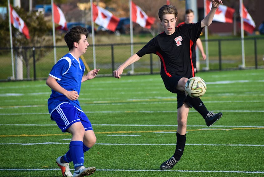 Jimmy MacInnis of the Sydney Academy Wildcats boys team, left, challenges Lucas Burke of the Glace Bay Panthers during Cape Breton High School Soccer League playoff action Wednesday at Open Hearth Park turf field. The Wildcats won, 3-1.
