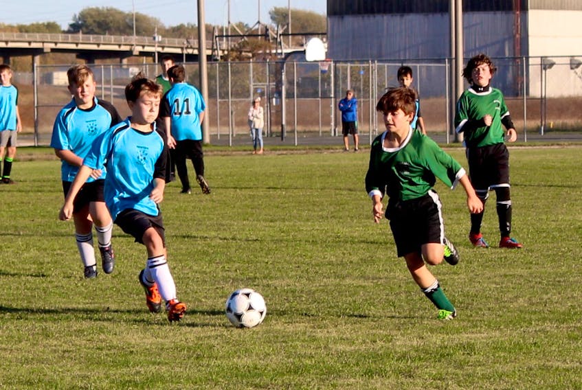 Hayden Thompson of Centre Scolaire Étoile de L'Acadie, left, and Forest Markotjohn of Breton Education Centre battle for the battle during Cape Breton Middle School Soccer League boys 'A' action at Steelman's Field in Sydney on Friday. CSEA won the game 1-0.