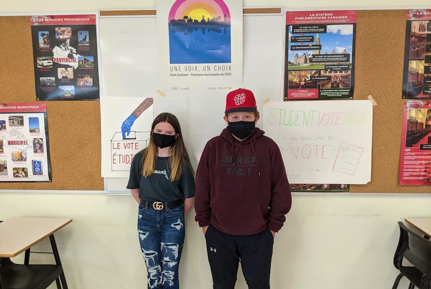Riverview High School Grade 9 students Ella MacArthur, 15, and Cohan Harries, 14, stand in the classroom where students cast their votes in the Cape Breton Regional Municipality's mock 2020 elections.
