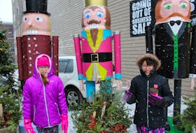 Ryleigh Googoo, left, and her cousin Jada Googoo-Levi stopped for some treats and to visit the giant Christmas decorations on display in downtown Sydney as part of the Nutcracker Festival, which took place Saturday afternoon on Charlotte Street.
