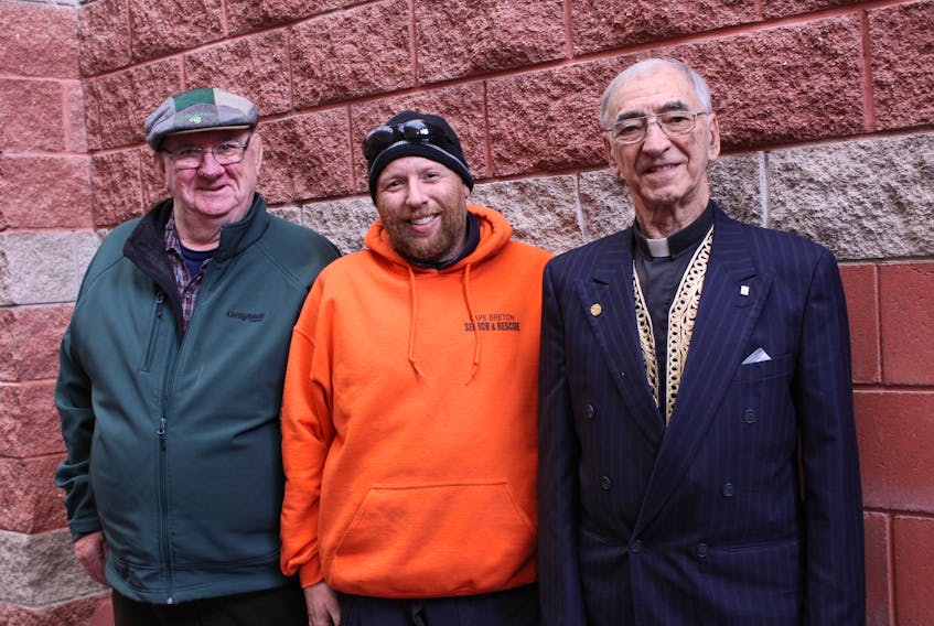 Two founding members of Cape Breton Search and Rescue, Allan Hanratty, left, and Fr. Albert Maroun, flank the group’s current-day president Greg O’Flaherty prior to Saturday’s banquet honouring CBSAR’s 50th anniversary.