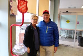 Steve Hogan, right, a longtime volunteer with the Glace Bay Salvation Army's Red Kettle campaign, stands with NSLC employee Sylia Smith in the Glace Bay location on Monday. Hogan isn't a member of the Salvation Army church and said he volunteers during their annual fundraising campaign because, "It's a good cause ... It benefits a lot of people." The fundraising campaign finishes on Dec. 24 and by last Friday the Glace Bay Salvation Army was almost half-way to its $75,000 goal.