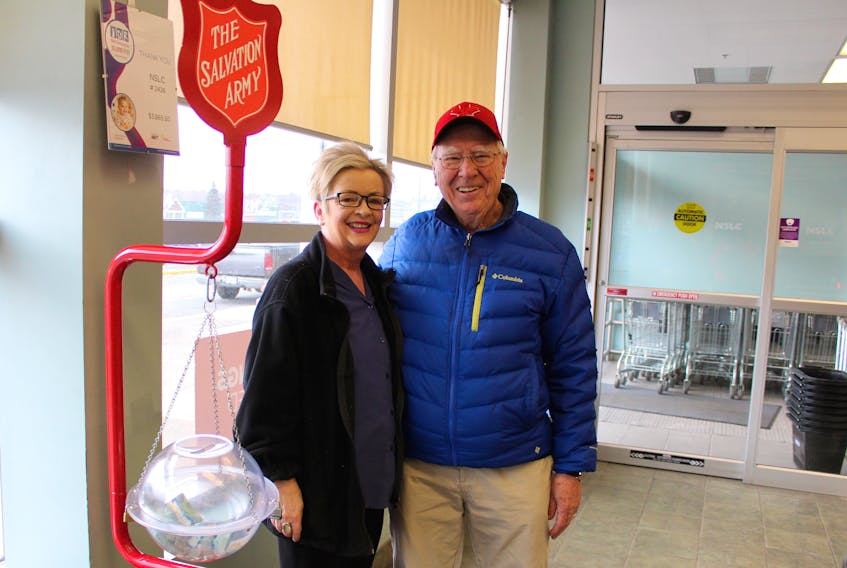 Steve Hogan, right, a longtime volunteer with the Glace Bay Salvation Army's Red Kettle campaign, stands with NSLC employee Sylia Smith in the Glace Bay location on Monday. Hogan isn't a member of the Salvation Army church and said he volunteers during their annual fundraising campaign because, "It's a good cause ... It benefits a lot of people." The fundraising campaign finishes on Dec. 24 and by last Friday the Glace Bay Salvation Army was almost half-way to its $75,000 goal.