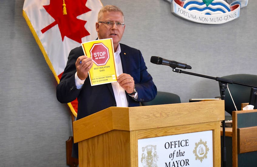 CBRM Mayor Cecil Clarke displays a sign indicating a self-isolation area. The poster is part of the new COVID-19/Coronavirus Information Kit that is being made available to the general public. Clarke provided an update Tuesday afternoon on the latest precautionary measures taken by the municipality to help limit the spread of COVID-19.