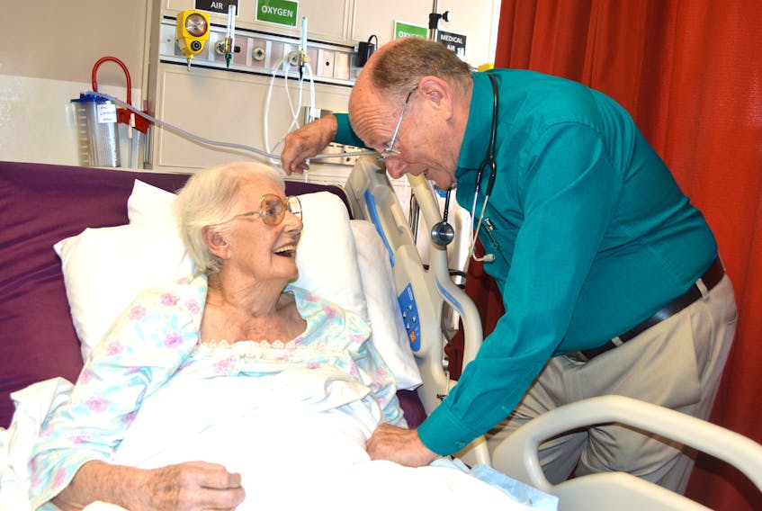 Dr. Peter Littlejohn, a family physician in New Waterford, chats with his patient Beatrice Jensen, 105, on the medical floor of the New Waterford Consolidated Hospital. After 44 years of practising in New Waterford, Littlejohn — who has in excess of 2,000 patients — is retiring at the end of July.