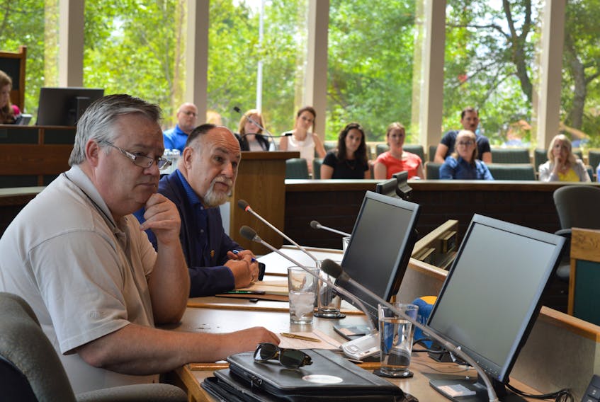 Coun. Eldon MacDonald asks a question while Coun. Steve Gillespie, foreground, looks on, during a CBRM special council meeting Wednesday where international tourism branding expert Roger Brooks offered his opinion of what will be required to rejuvenate downtown Sydney.
