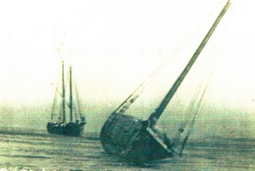 Two schooners aground on the sandbar near Lingan around 1935. Dawson City is the ship in the foreground.