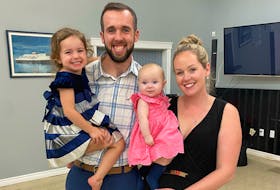 Cyril MacDonald, 27, takes a photo with his wife, Kailin Keigan, and their daughters Zoey (in his arms) and Quinnleigh after winning the seat for District 3 in the Cape Breton Regional Municipality's 2020 election. MacDonald waited for results at the Georges River Fire Hall with family, friends and supporters.
