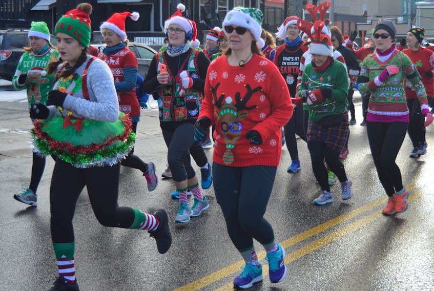 About 80 people took part in the sixth annual Ugly Sweater Run for Transition House on Sunday. The event collected money and presents for children and youth who used Transition House in the last year. It was one of the biggest ones to date with about 50 presents, books and $1000 cash donated.