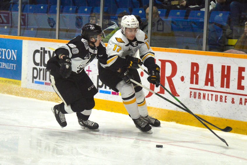Cole Fraser of the Cape Breton Eagles, right, works his way around Blainville-Boisbriand Armada defenceman Miguël Tourigny during recent Quebec Major Junior Hockey League action at Centre 200 in Sydney. Fraser returned to the lineup last month after missing 29 games due to injury.