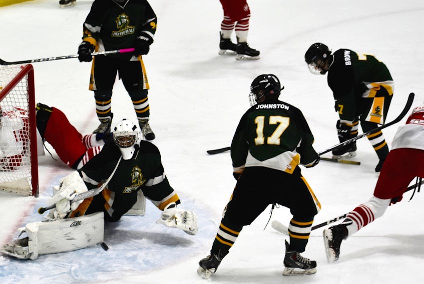 In this December file photo, Jonathan Dolomont of the Memorial Marauders, left, makes a big blocker save on Josh MacAskill of the Riverview Redmen, right, during  Cape Breton High School Hockey League action at the Cape Breton County Recreation Centre in Coxheath. The Cape Breton High School Hockey League was fairly young in 2018-19, which should make for an even more entertaining league in 2019-2020.