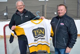 Kenny Tracey of Glace Bay, right, presents Bruce Campbell of New Waterford with his 1998 Allen Cup-winning jersey. Campbell gave Tracey his jersey following the championship game of the tournament. On Wednesday, Tracey gave the jersey back after having it at his home for 23 years.