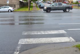 A motorist goes through a faded crosswalk located on George Street across from Centre 200 in Sydney.