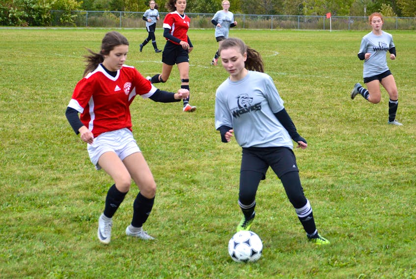 Gianna Sheppard of the Breton Education Centre Bears, right, battles for ball possession with Lilly Farrell of the Riverview Reds during Cape Breton High School Soccer League girls junior varsity action at Riverview High School field on Tuesday. The teams tied 1-1. Courtney Trask had the lone goal for the Reds, while Isabella White netted the Bears goal. Full high school and middle school soccer results from Tuesday in today's sports section. JEREMY FRASER/CAPE BRETON POST