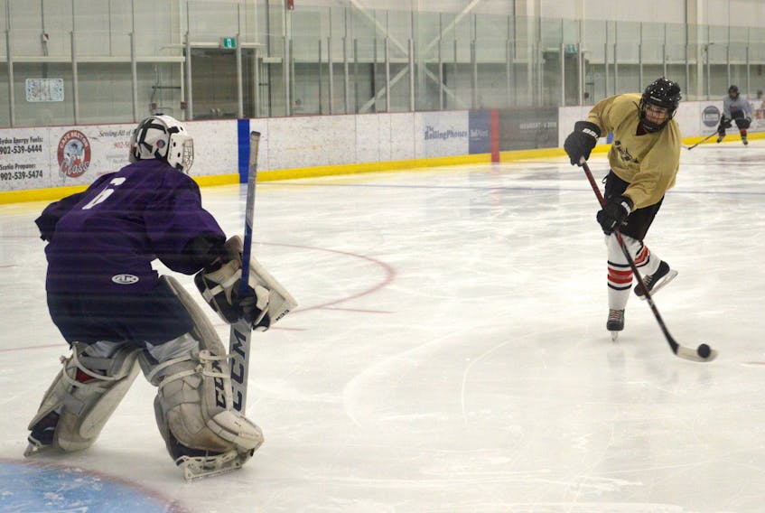 Tyler Cormier, right, prepares to take a shot on teammate and goaltender Darien McInnis during a Cape Breton Jets practice at the Membertou Sport and Wellness Centre on Tuesday. The Jets and Cabot Highlanders of Port Hawkesbury will represent the island in the Nova Scotia Minor Midget ‘AAA’ Hockey League this season.