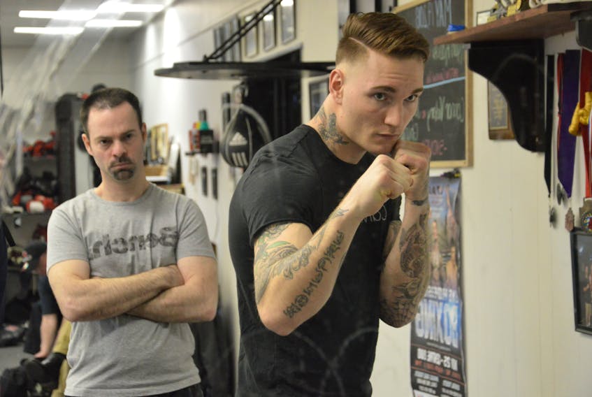 Ryan Rozicki of Sydney Forks shadow boxes in the mirror while under the watchful eye of coach Glen Williams on Thursday at Thunder Boxing in Sydney. Rozicki will fight Alvaro Enriquez of Mexico in a 190-pound bout at the Boxing Night in Canada fight card at the Pictou County Wellness Centre on Saturday.