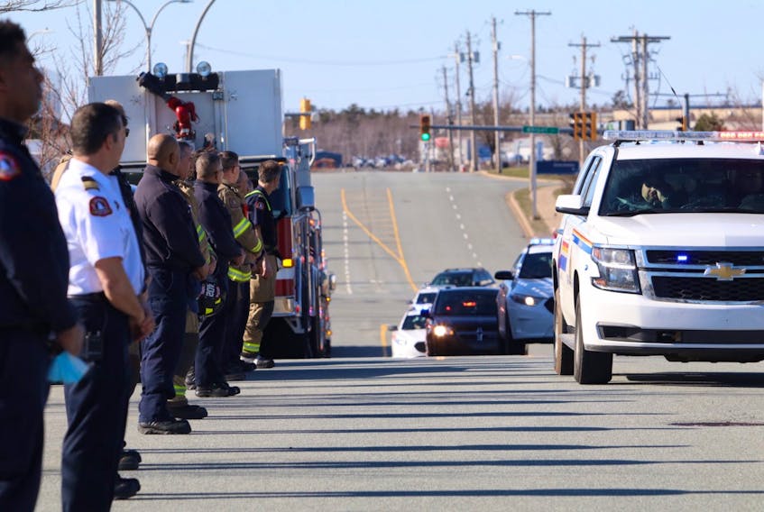 Police, firefighters and emergency personnel line Garland Avenue in Burnside as the body of an RCMP officer is transported to the Dr. William D. Finn Centre for Forensic Medicine for an autopsy Sunday evening.