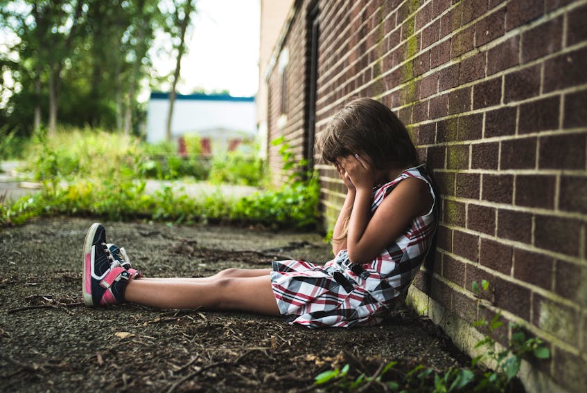 This stock image illustrates the despair felt by a child living in poverty.