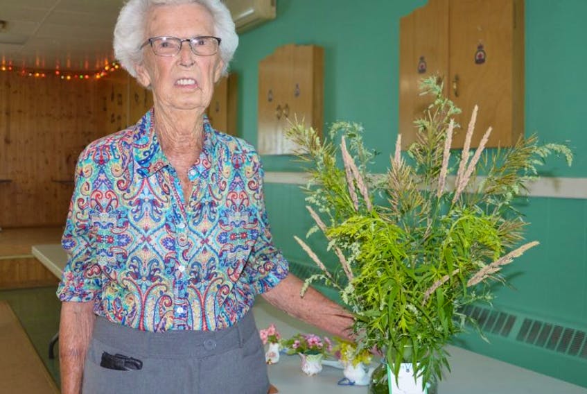 Yvonne Johnstone is shown with one of her favourite flowers. The 89-year-old, one of the longest serving members of the North Sydney Garden Club, participated in the 50th annual rose and flower show, hosted by the club at the Royal Canadian Legion in North Sydney on Tuesday.