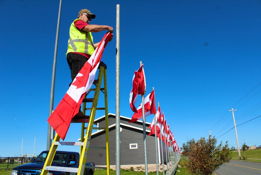 Nova Scotia Lands employee Steve Gillis is shown raising some of the Canadian flags that will be part of the Veterans Voices of Canada Flags of Remembrance ceremony at Open Hearth Park in Sydney recently.Every year, 128 full-size official Canadian flags are raised along major roadways and other highly visible locations in participating communities across Canada. Flags represent the more than 128,000 Canadians Military and RCMP killed or missing in action from the South African War to present day. This year, a tribute was given to first responders during the ceremony. The flags will remain raised until Nov.12.