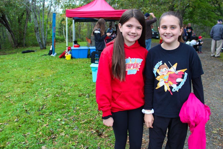 Aubreigh MacArthur, left, stands with her cousin Cate Macaulay, at the start of Caleb’s Courage Superhero Walk, Run or Fly fundraiser on Sept. 15. MacArthur is Caleb’s brother, who died from cancer in 2015, and she cut 14 inches off her hair at the event to be donated to Angel Hair for Kids – a program that provides wigs to children who need them. It was the third time she cut her hair for a wig donation but the first time she asked people to sponsor her to do and the 10-year-old raised $3,500 doing so.