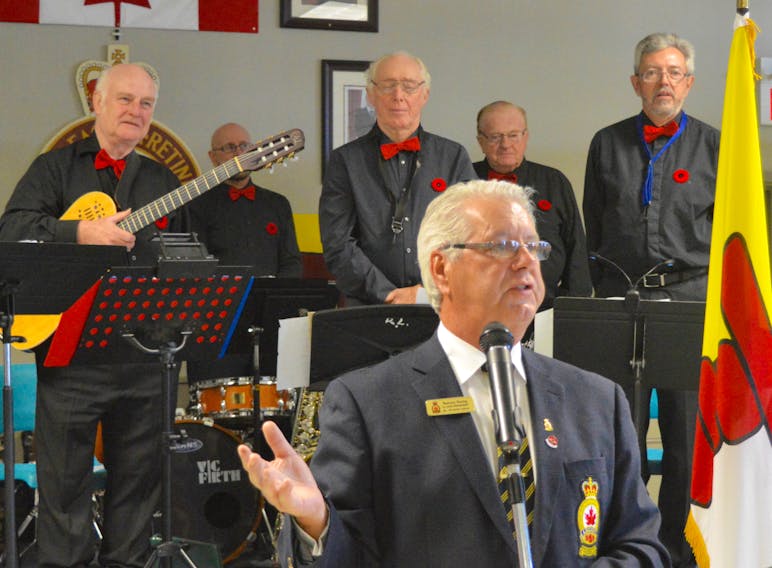 Ashby legion president Tommy Young unveils details of this year’s Sydney Remembrance Day ceremony that will be held at Centre 200, while members of the Steppin’ Out swing band look on. The band will take part in the Nov. 11 event as part of the Highland Arts Theatre’s ‘Tribute to the Vets’. DAVID JALA/CAPE BRETON POST