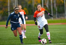 Ciera Disipio, right, of the Cape Breton Capers carries the ball while Renee Bugler of St. Francis Xavier X-Women chase during Atlantic University Sport women’s soccer action at the Cape Breton Health Recreation Complex in Sydney on Friday. Cape Breton won the game 3-0.