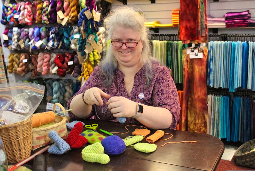 Janet Dawson, owner of the Bobbin Tree in Sydney, sits and sews some knit packers on Nov. 19 at her store. The design for these packers was created by Dawson who kicked off a campaign to get 65 of these and 20 breast forms (knockers) made before mid-December to be donated to transgender people who want or need them.