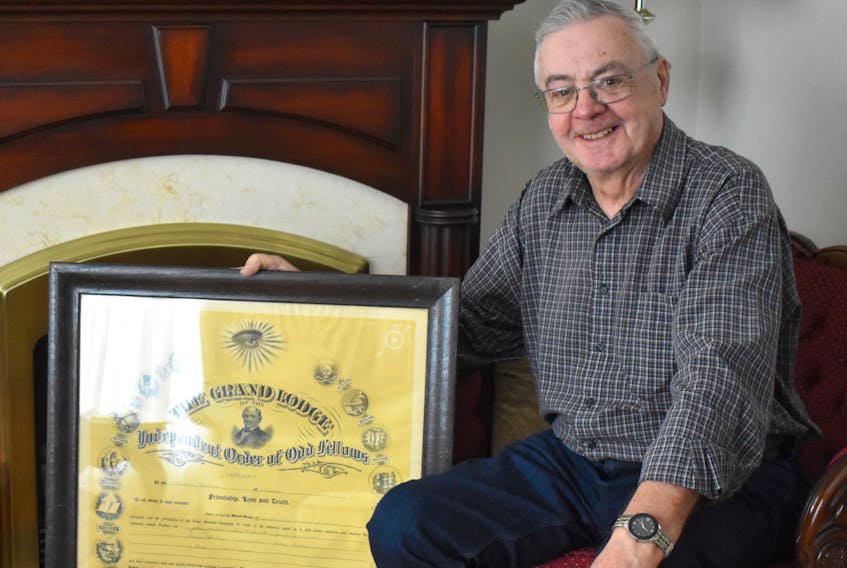 Kent Atkinson, 79, sits in the living room of his Glace Bay home with the original Odd-Fellows charter, which hung on the wall of the building the community service club owned from 1908-2014. The building, located on the corner of Catherine and Commercial streets, was sold in 2014 and destroyed by fire on Jan. 18, 2020. NIKKI SULLIVAN/CAPE BRETON POST