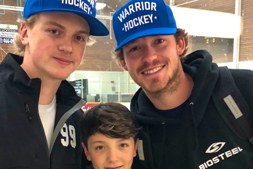 Daniel Levatte, centre, stands with Graysen Cameron, left, and Tyler Smith at a Gretzky Hockey School camp in Edmonton in 2019. Cameron and Smith were junior coaches at the camp and are two of the 13 survivors of the Humboldt Broncos bus accident which resulted in the death 16 other people in April 2018.