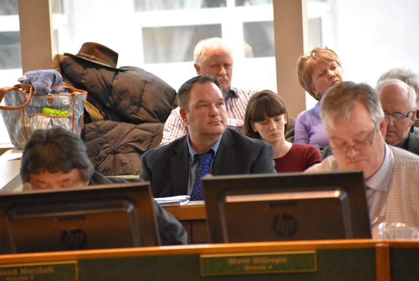 Calgary developer Chris Skidmore listens during Tuesday’s public hearing into his application to have a 109-acre plot of land rezoned to allow for the development an RV park and campground.
