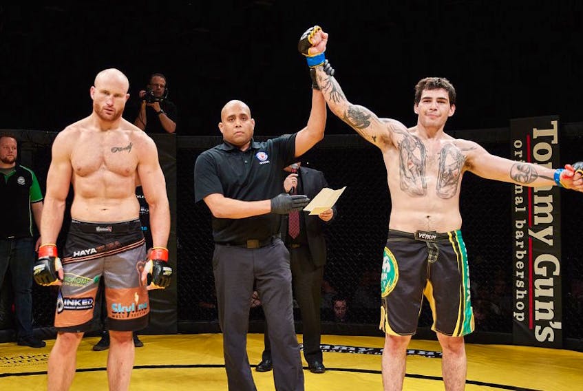 Refeere Jerin Valel indicates the winner Steven MacDonald, right, of New Waterford following an Xcessive Force Fighting Championship match in Grande Prairie, Alta., last month. The fight was MacDonald’s first professional mixed martial arts match. MacDonald defeated Kyle (Frankenstein) Francotti, left, of Grande Prairie with a first-round knockout for his first pro win.