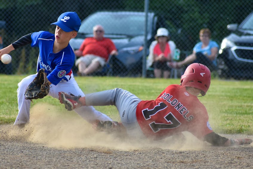 Keegan O’Neill, right, of the Glace Bay McDonald’s Colonels slides safely into second base as Thomas Estrabooks of Lancaster prepares to place a tag during Atlantic Major Little League Championship action at Cameron Bowl in Glace Bay on Friday.