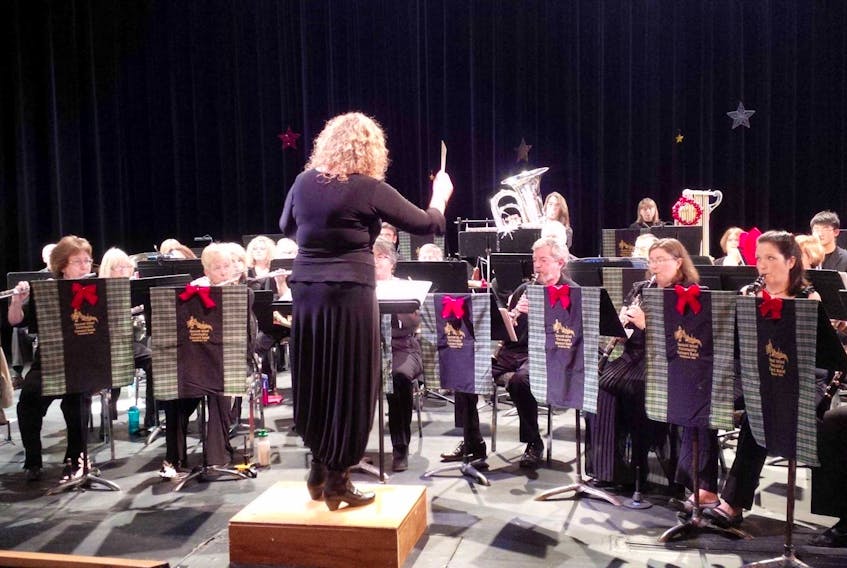 Conductor Laura Mercer conducts the Second Wind Community Band during a recent performance.