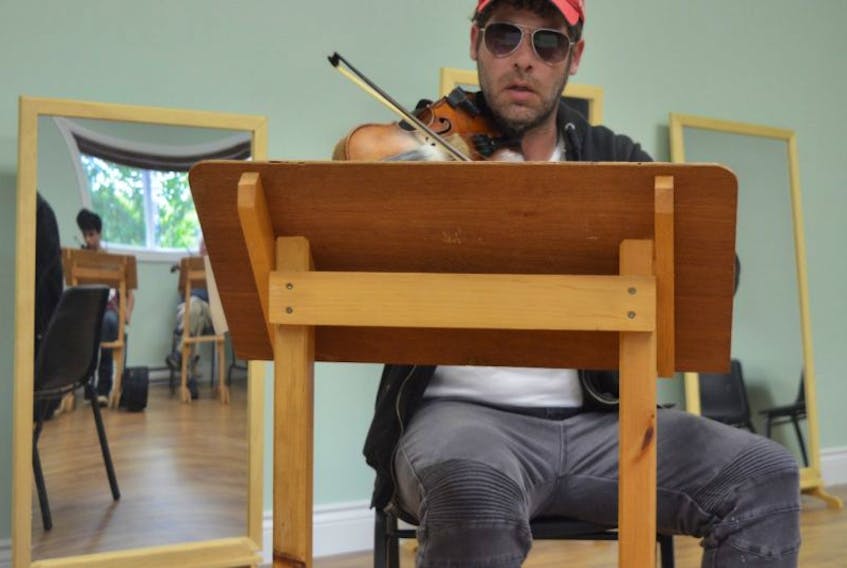 Cape Breton fiddler Ashley MacIsaac is seen instructing students at the Cape Breton Fiddlers’ Association’s annual Festival of Cape Breton Fiddling on Saturday at the Gaelic College in St. Anns.