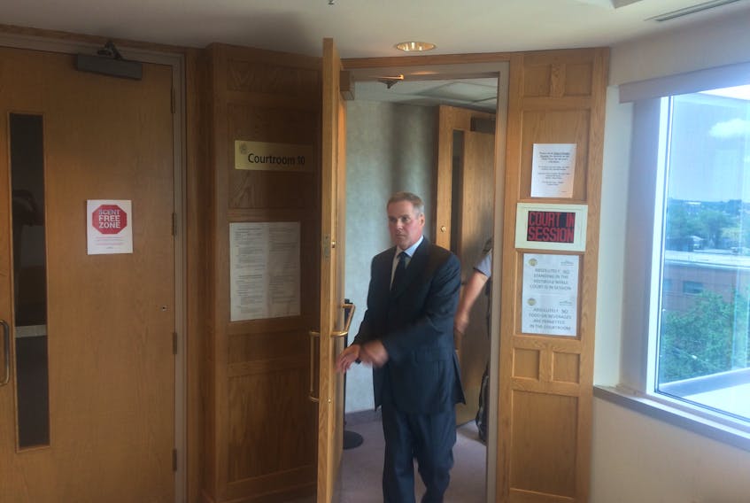 John Whalley, former economic development officer with the Cape Breton Regional Municipality, leaves a Sydney courtroom Monday after testifying in the first day of a trial into his wrongful dismissal suit against the municipality.