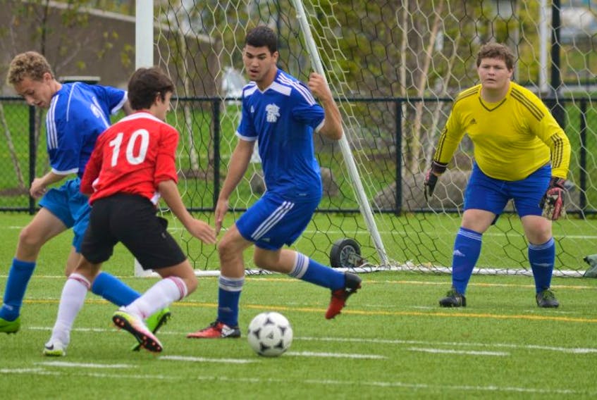 David Quinzanos of the Riverview Reds takes a shot at the Sydney Academy Wildcats goalie Stephen MacDonald-Campbell during a Cape Breton High School Soccer League boys game on Wednesday at Open Hearth Park. Riverview shut out Sydney Academy 3-0.
