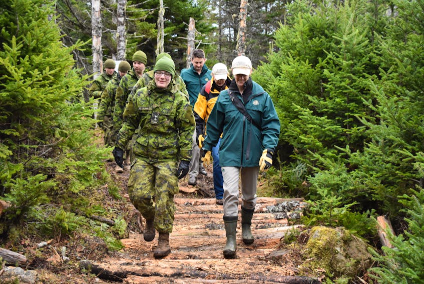Parks Canada employees and members of the Canadian Army 4 Engineer Support Regiment march along the newly cleared siege corridor near the Fortress of Louisbourg. Nikki Sullivan/Cape Breton Post