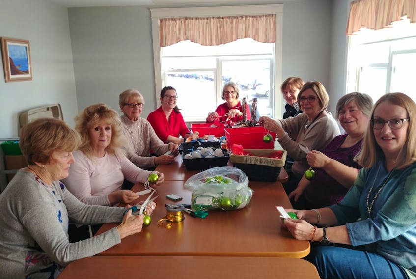 Volunteers are busy preparing bells for the 10th annual Bells of Care evening at the Northside Community Guest Home. From left, Corinne MacDougall, Joan Musbally, Erma Carmichael, Hailey Marinelli (fundraising co-ordinator), Glenda McKeough, Joanne MacNeil, Joan Gallagher, Lila Howell and Catherine Collins.