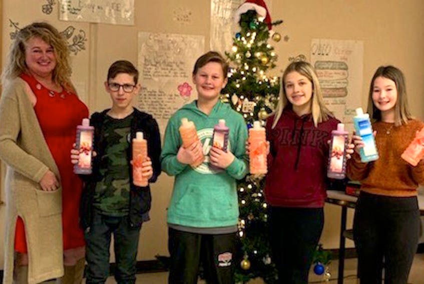 Oceanview Education Centre teacher Lisa Roach, from left, Grade 8 students Ben Peach, Ryan Aucoin, Kylee Byrne-King and Kyra Turnbull, who are four of the top salespeople in their bubble bath campaign, which helps raise money for a Christmas adopt-a-family program.