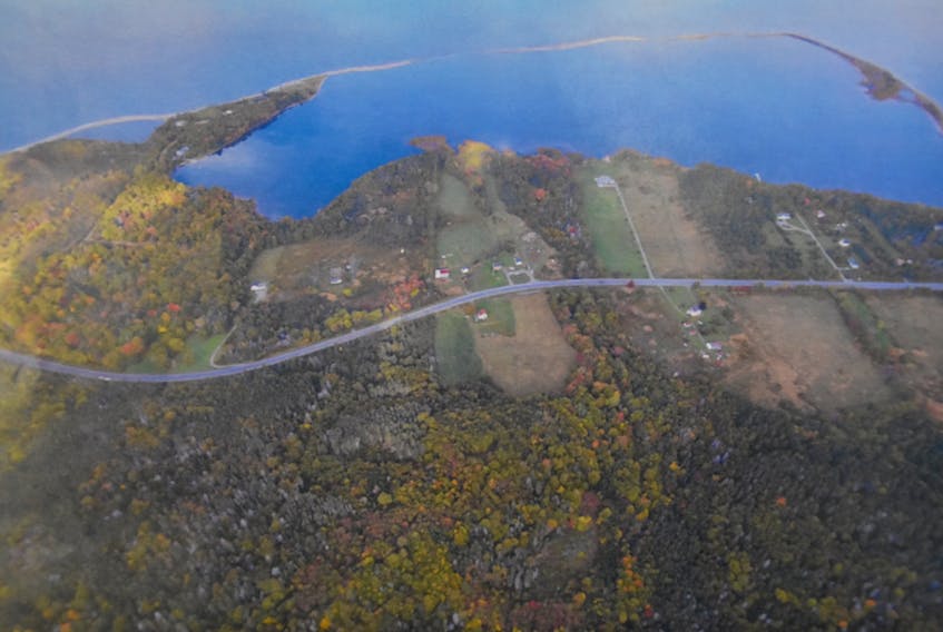 This aerial view of Big Pond Centre shows the “barachois” or coastal lagoon that defines the area. A 541-site RV park and campground are proposed for a 109-acre parcel of land that includes about 1,000 feet of shoreline located just left of the cleared area in the centre of the photo. The proposed site’s four-hectares of land extends south across the highway and up the slope of the land.