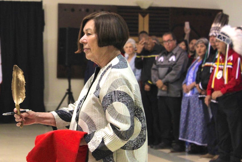Marlys Edwardh, a retired Canadian civil rights lawyer who helped vindicate Donald Marshall Jr., carries a repatriation feather on behalf of Marshall’s family. A sacred symbol of First Nations culture, the feather was later presented to presiding provincial court judge Laurie Halfpenny MacQuarrie during the official opening of the court on Thursday at the Wagmatcook Culture and Heritage Centre.