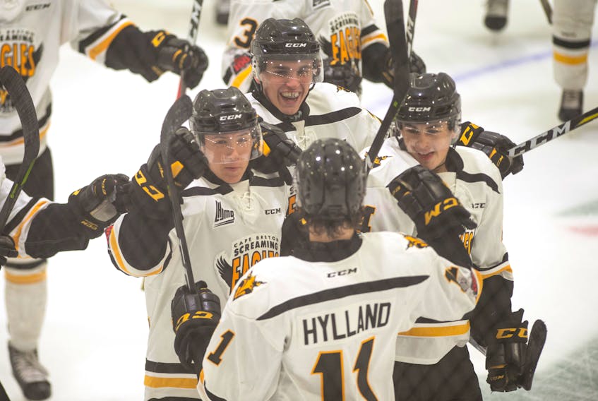 Cape Breton Screaming Eagles players congratulate teammate Tyler Hylland after he scored the overtime winner to lead the Screaming Eagles to 3-2 preseason win over the Halifax Mooseheads at the Dartmouth 4 Pad Arena on Tuesday.