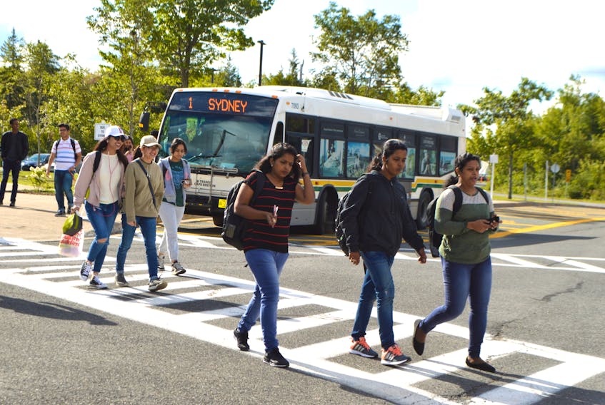 Students depart from a Cape Breton Regional Municipality transit bus at Cape Breton University on Friday. Students are saying transit buses as usually too full and not frequent enough.