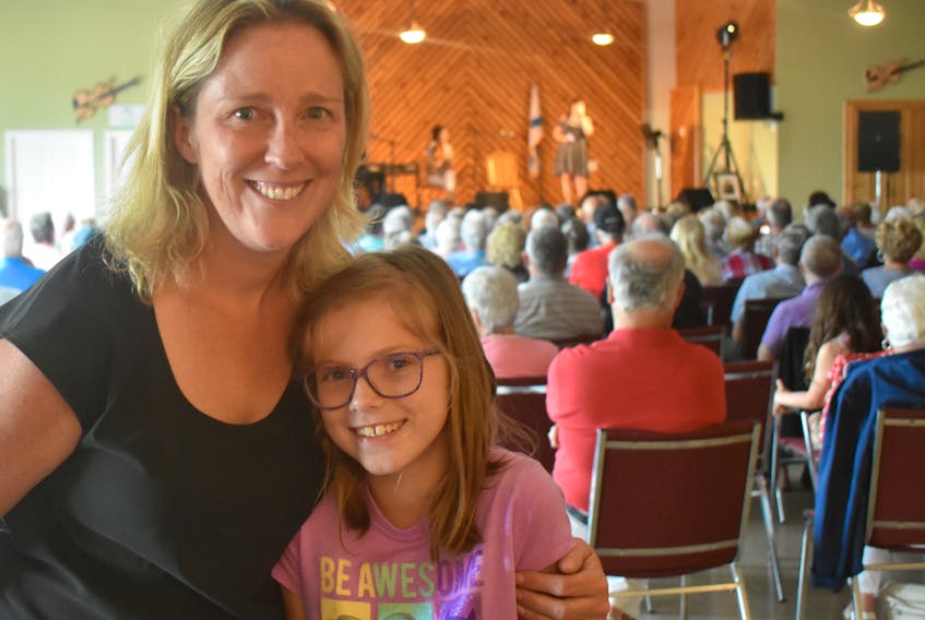 Cape Breton native Thea (Gillis) Campbell and her daughter Mairin, who live in Yellowknife, N.W.T., were part of the crowd at the 2018 Big Pond Festival Sunday Concert that was held at the Big Pond Fire Hall. Mairin, who turns nine-years-old today (Monday), is the grand-niece of the late Rev. Joe Gillis, a fiddle-playing priest for whom this year’s event was dedicated.