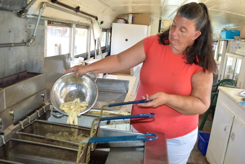 Jeanette MacDonald, a cook on the Glace Bay Y’s Men’s and Women’s Club’s TCL food truck, makes fries on the chip wagon. The club says due to a shortage of 50-lb. bags of potatos expected to continue the next several weeks, they are going to be forced to close the food truck down months earlier than usual, taking several jobs with it.