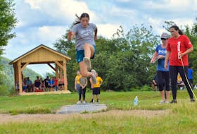 Kassie Stevens takes part in the long jump during the Nova Scotia Mi’kmaw Summer Games track and field day at Whycocomagh Education Centre on Thursday. The weeklong games, which are being hosted by We’koqma’q First Nation, wrap up Sunday.