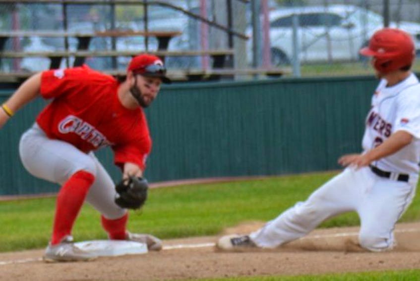 Mike Tobin of the Sydney Sooners, right, slides into third base during Canadian men’s senior baseball championship action against Newfoundland and Labrador in Miramichi, N.B., on Thursday. Sydney won the game 6-3. CONTRIBUTED/BRIAN RICHARD